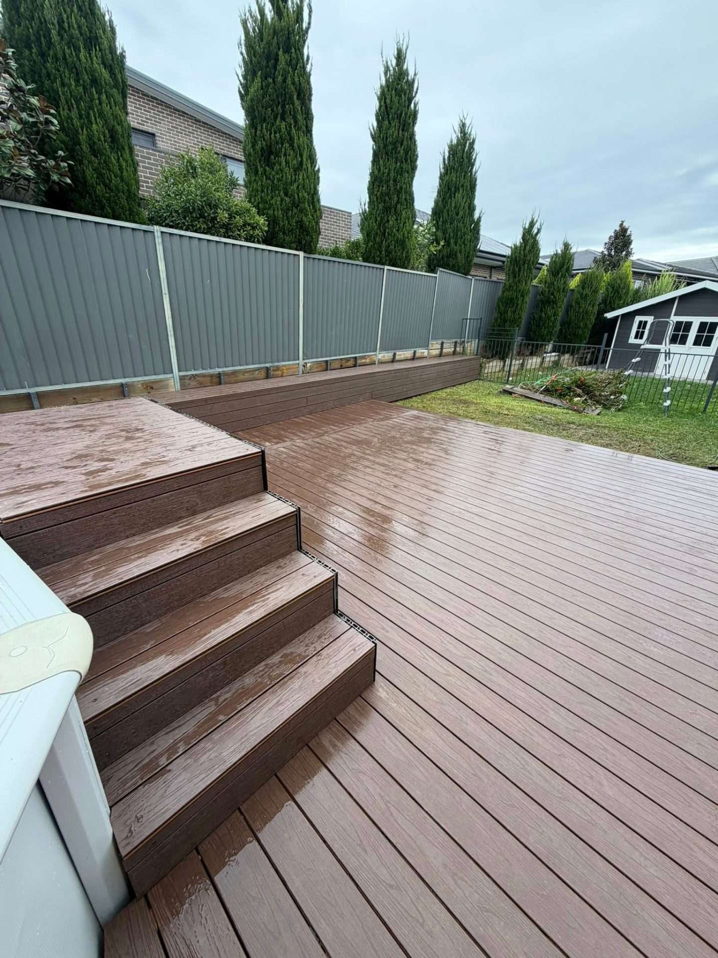 Composite timber decking with custom steps installed by Rilton Building Group in the Lower Blue Mountains