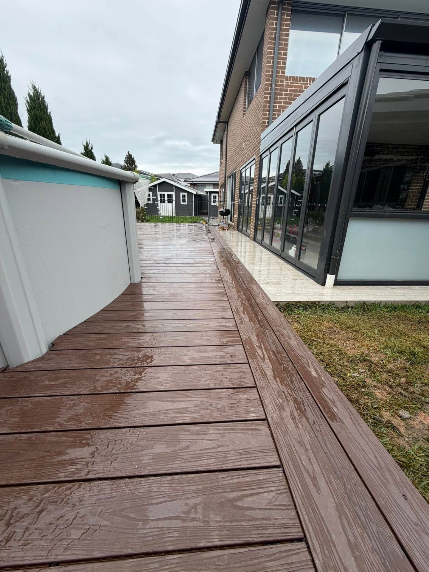 Composite decking walkway alongside swimming pool by Rilton Building Group in Western Sydney